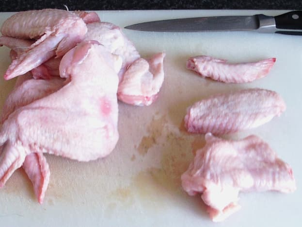 Chopping fresh chicken wings