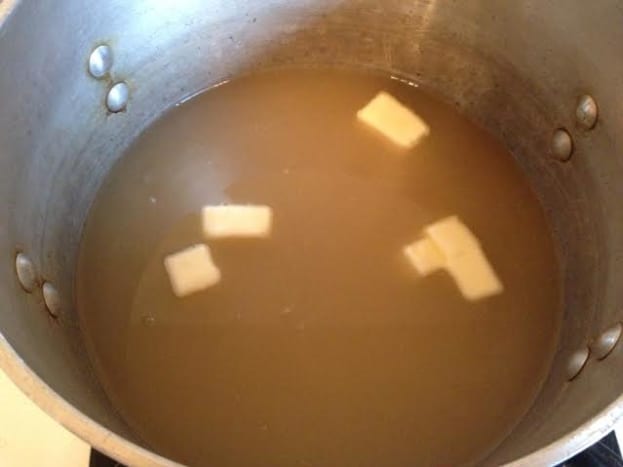 Pour the broth into a saucepan (I used a 5qt. pan) and add 1 tablespoon of butter.