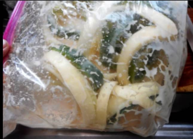 Add onion and pepper to a ziplock bag. 