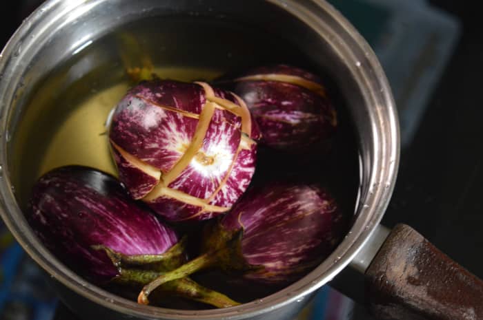 Step one: Slit the eggplants vertically and immerse in water.