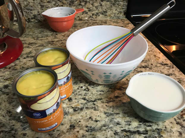 Condensed soup, milk, bowl, and whisk.