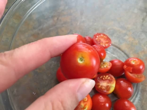 I slice my cherry tomatoes right through the center, where the stem attaches.