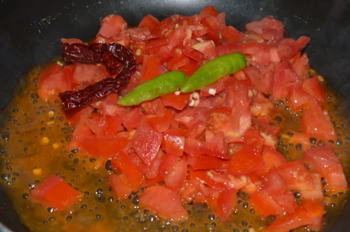 Step one: Saute green chili, red chili, and tomatoes in some oil.