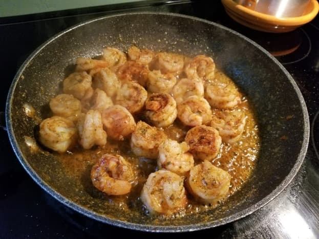 Delicious shrimp simmering in seasoned butter.