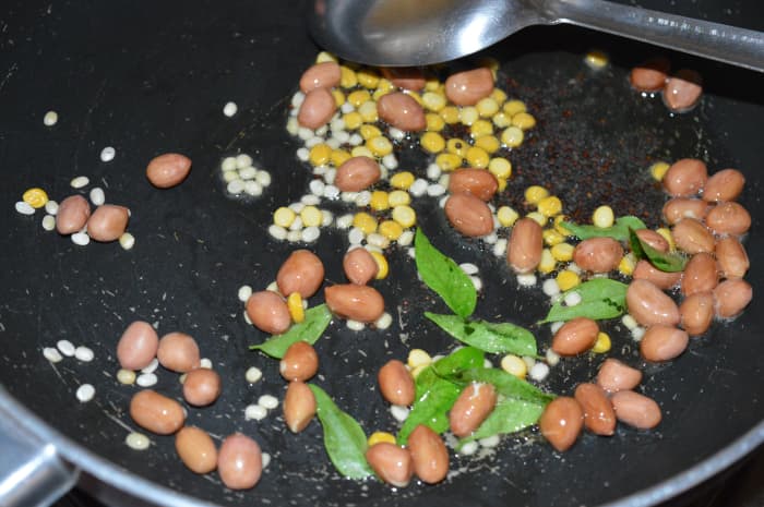 Step one: Make a tempering with mustard seeds, white lentils, split chickpeas, curry leaves, and peanuts. Saute until the mustard crackles and peanuts become crispy.