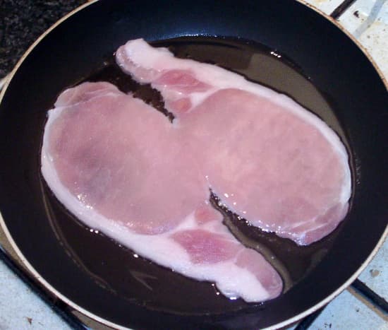 Back bacon is put on to fry