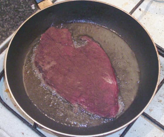 Starting to fry spiced steak