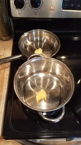Start by melting butter in a large pot and a saute pan.