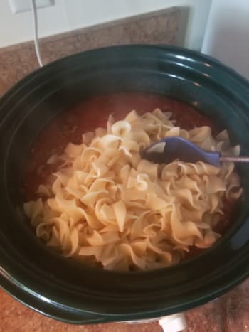Once noodles are cooked, drain and add them to the crock-pot. Stir.