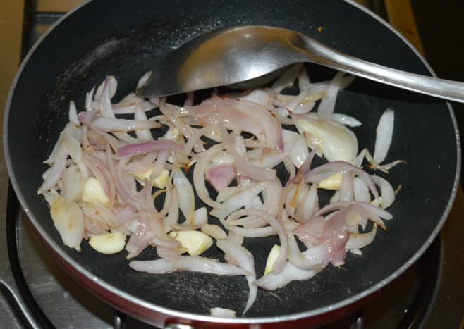Step one: Heat olive oil in a deep bottomed pan. Throw in chopped onion and garlic. Saute until onions turn pinkish.