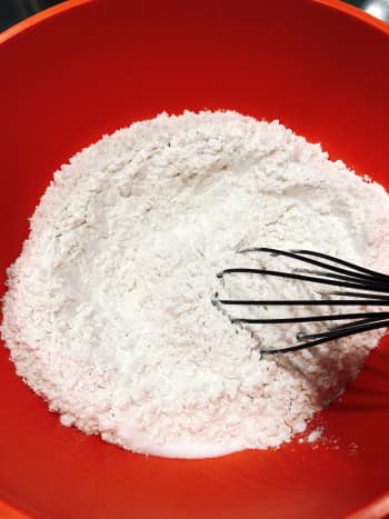 Use a whisk to mix the dry ingredients in the bowl. 