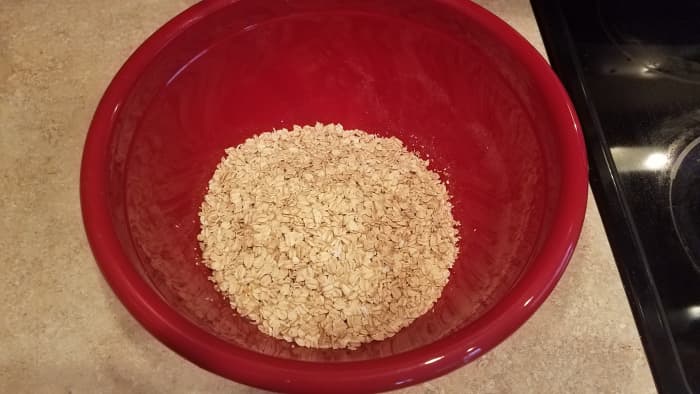 Start by pouring your oats into a large mixing bowl.