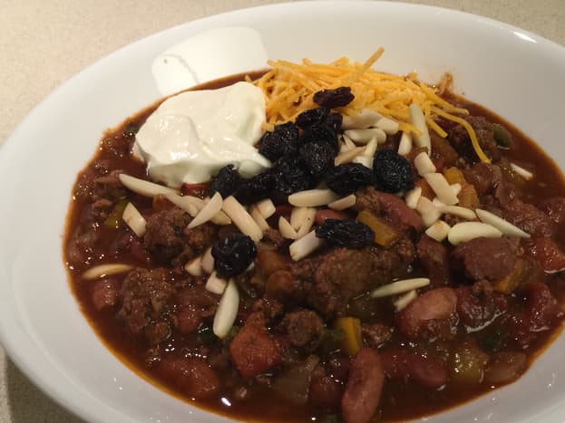 Fruit and Nut Chili with raisins, almonds, cheese, and sour cream