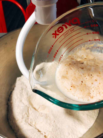 Add the yeast mixture into the mixing bowl. 
