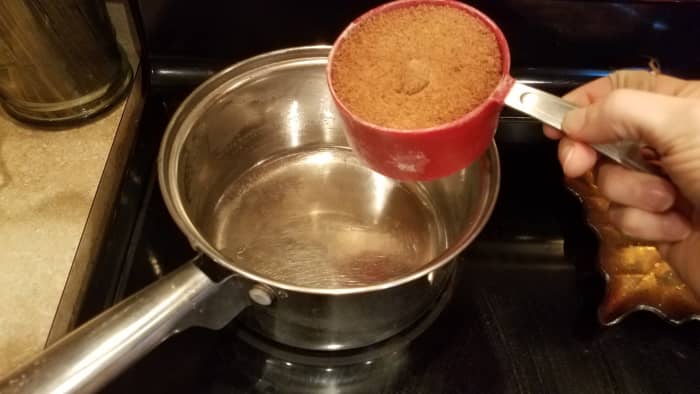 Shown one ingredient at a time. First pour your coconut sugar into your pot.