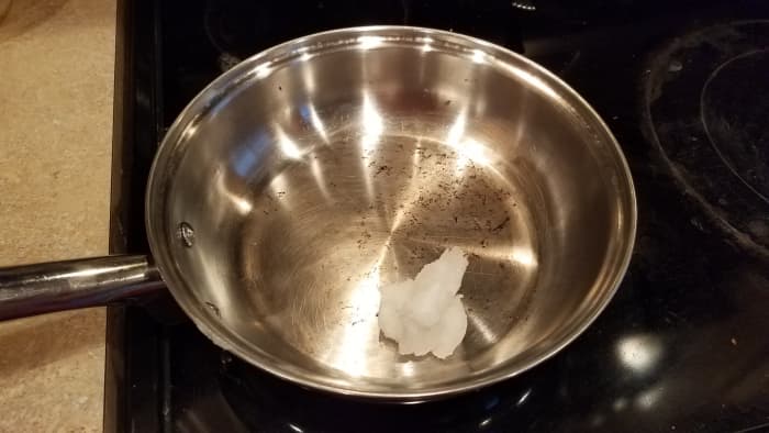 Start by melting your coconut oil in a pan on the stove over medium heat.