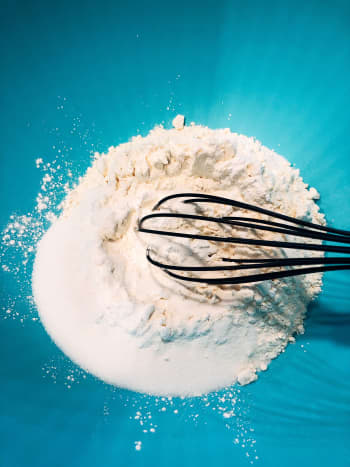 In a mixing bowl, combine the flour, sugar, baking powder, and salt. Use a whisk to combine the dry ingredients.