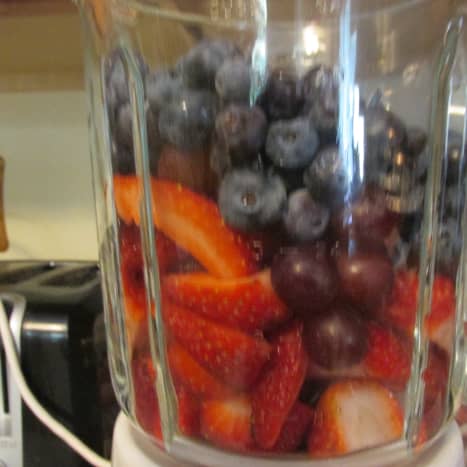 Place the fruit in the blender.