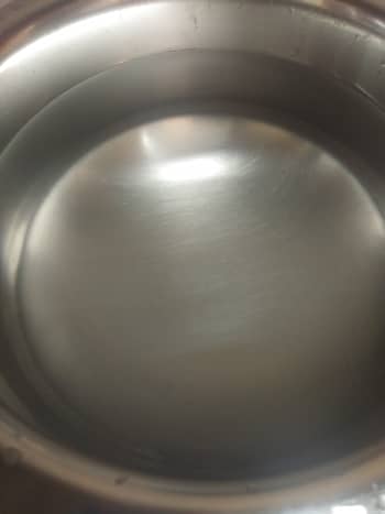 In a wide pan or vessel, add water.