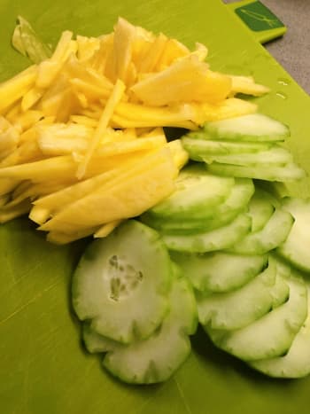 Thinly sliced cucumber, pineapple, and mango. 