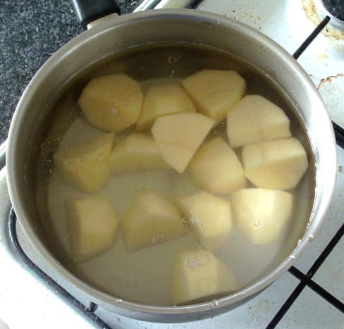 Chopped potatoes are steeped in cold water