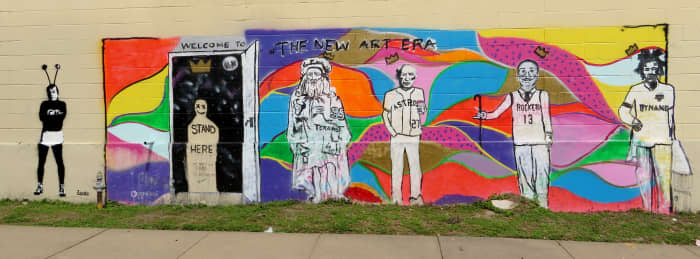 The &quot;New Art Era&quot; mural on Polk Street near the &quot;We Love Houston&quot; sculpture by David Adickes