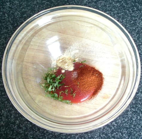 Spiced onions sauce ingredients are combined in a mixing bowl