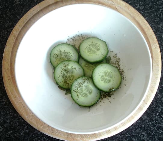 Pickling cucumber slices with white wine vinegar and dill