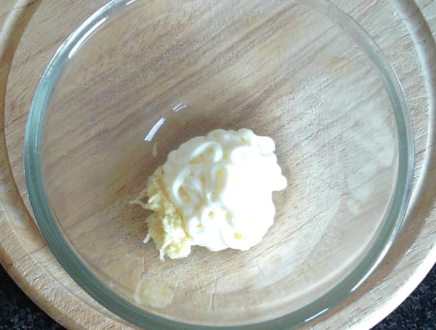 Grated garlic and mayo are combined in a small bowl