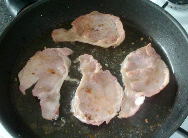 Bacon is gently fried in oil