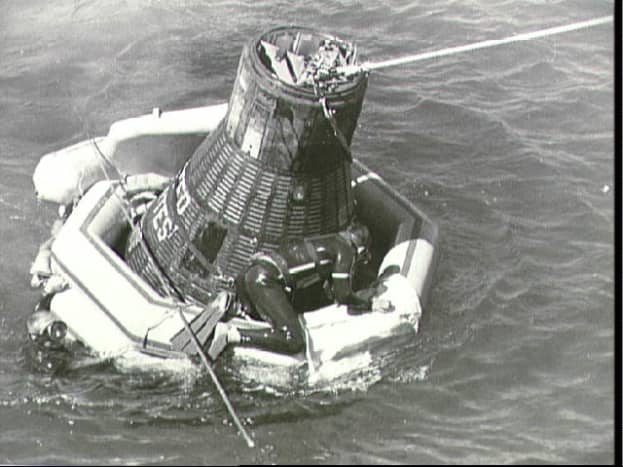 Sigma 7, with flotation collar attached, awaits recovery. Photo courtesy of NASA.