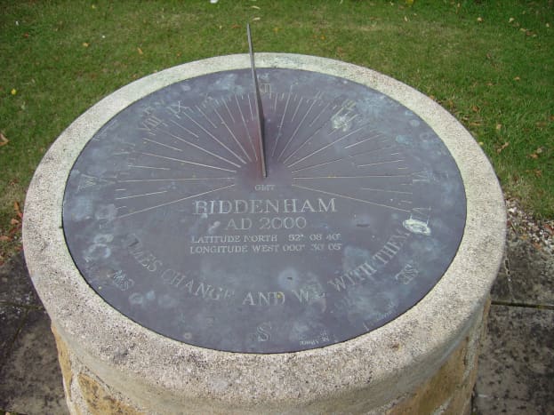 This is a horizontal sundial sporting all the features a sundial has to offer. If you look closely at the bottom of the face, you will see the motto, &quot;Times change and we with them&quot;.
