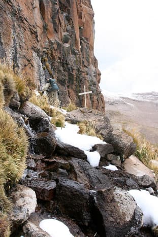A cross marks the point in the Andes mountains where the Amazon River originates.