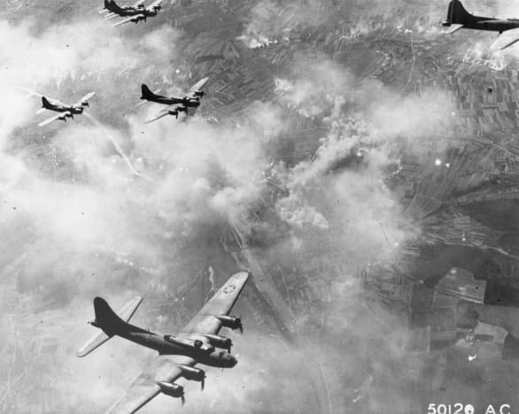 Boeing B-17Fs in formation over Schweinfurt Germany August the 17th 1943. Note the smoke on the ground from the bomb run.