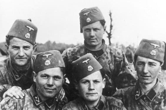 Bosnian members of the 13th SS Division. Note the traditional Fezzes (with German Eagle and Skull). Note also the middle-eastern scimitar swords on their collar patches.