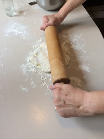 Using gentle pressure begin rolling out the dough.