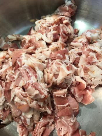 Start with dicing the bacon, or the bacon and ham if you are using both. Render over medium low heat and be patient, You want to get as much of the bacon grease out of it as possible, and low, long cooking does it best.