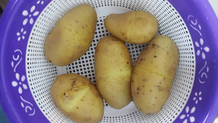 Slits made in potatoes for easy boiling and peeling. 
