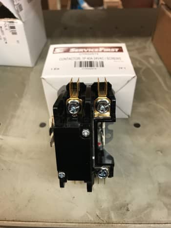 A single pole contactor only has to connect one wire for power. The other leg is just the neutral/common and is always in the circuit. On this part, the plunger is under the cover you see here.