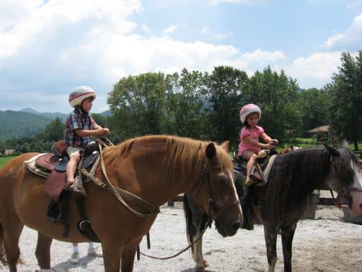 Two of the grands about to go trail riding. Notice the riding helmets?