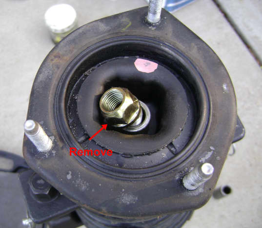 Remove the upper strut mount nut and bushing