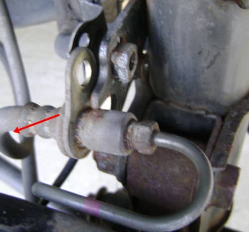 Carefully remove the brake line hose from the strut assembly