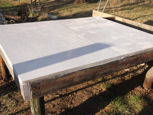 The new hen house began with a raised platform at a convenient height for us to reach in and replace straw, and easily catch the chickens when necessary. No need to bend down to ground level. We painted the floor to seal it. 
