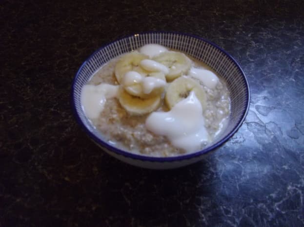 Bowl of porridge with banana and yoghurt.