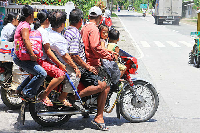 Riding a motorcycle or habal-habal in the Philippines. 