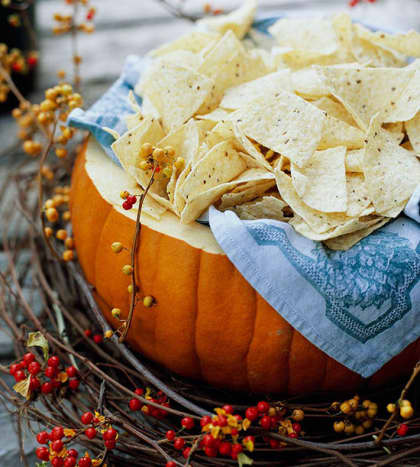 Dips or chips can be served in a pumpkin when hosting a party.