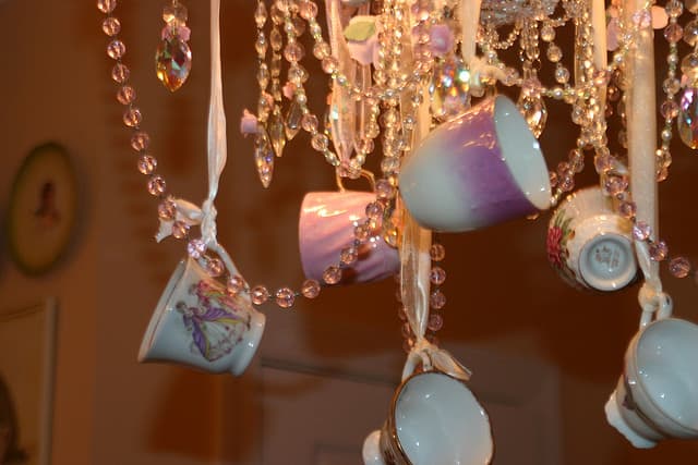 Hanging small teacups from a chandelier is such a lovely idea!