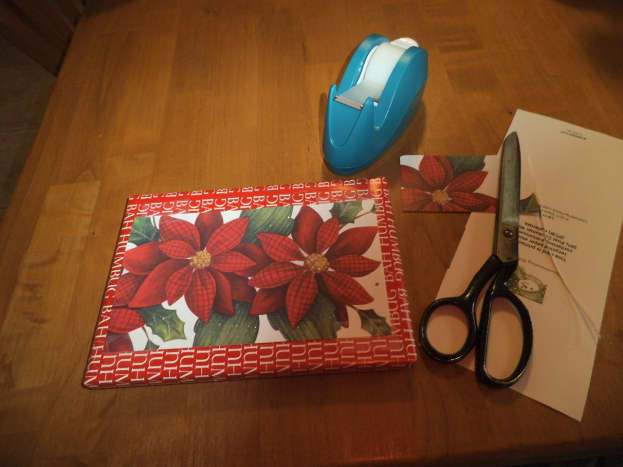 Save the cards from earlier years and cut off the colorful pictures. You can use simple brown paper wrapping which sets off the holiday card nicely. For small gifts, reuse paper saved from last year, cut down to smaller size to remove the tape marks.