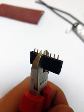 Using the cutting pliers, cut at the middle of the 5th pin if you're building a 4-pin connector. General rule: cut at the n + 1/2 pin for a connector with n pins.
