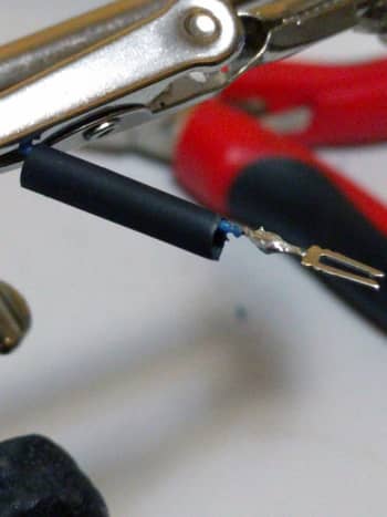 Cut a bit of shrink-wrap and make sure you cover the solder point before applying heat.